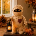 Close-up of cute Halloween mummy decoration figurine holding a glowing black lantern - Mummy Style