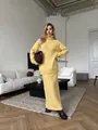 Woman wearing a loose yellow knitted wool blend turtleneck sweater and matching skirt - M / Top And Bottom / Light Yellow