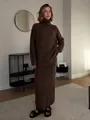 Model wearing a cozy brown wool blend knit sweater and matching long skirt in a modern interior - Brown