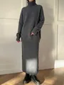 Full-length view of a gray wool-blend knitted sweater and matching midi skirt set. - Gray