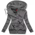 Close-up of grey slim-fit hoodie featuring asymmetrical zipper and drawstring hood - S / Tops / Gray