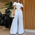 Detailed full-body view of a white wide-leg jumpsuit with a hollow waist design. - S / Set / White