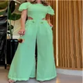 Detailed shot of trendy mint green jumpsuit featuring waist cutouts and wide leg fit - S / Set / Green