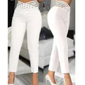 Close-up detail of white high-waisted pencil pants with hollow waistband design - S / Bottoms / White
