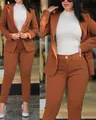 Detail shot of a burnt orange women's two-piece suit with double-breasted blazer. - Coffee