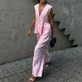 Woman wearing a pink sleeveless V-neck vest and wide-leg trousers set in a street setting. - S / Top And Bottom (K25003) / Pink