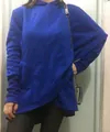 Detail view of women's bright blue long-sleeve hooded sweatshirt with a unique asymmetrical hem design - S / Tops / Blue