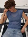 Detail view of a blue sheer knit sleeveless vest for women on a model in studio - S / Tops / Teal