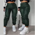 Detail view of women's dark green PU leather cargo pants featuring stylish flap pockets - S / Green