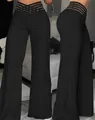 Detail of black high-waisted wide-leg trousers with wavy plissé texture and cut-out waist. - S / Bottoms / Black