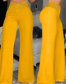 Detalle de pantalones de pernera ancha en amarillo vibrante con cintura calada - S / Bottoms / Amarillo