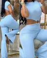 Close-up detail of a light blue ribbed jumpsuit featuring a stylish waist cutout with a ring - S / Light Blue