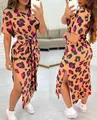 Detailed view of the vibrant leopard print and side slit on the tie-waist dress. - S / Dresses / Khaki Black Floral Pattern