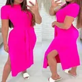 A detailed view of a vibrant fuchsia midi dress featuring a side slit and waist tie - Rose Red