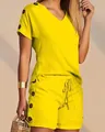 Detailed view of yellow V-neck top and shorts two-piece set with button accents - S / Yellow