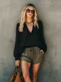Elegant woman in a black V-neck long sleeve blouse and olive green shorts for a casual look. - S / Tops / Black