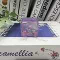Close-up of a purple ocean-themed ice cube squishy toy with mini seashells inside - Purple