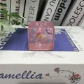 Close-up detail of a transparent ocean themed squishy toy with fish and star inclusions - Pink
