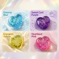 Detailed view of heart-shaped glitter squishy stress relief toys in four vibrant colors - Aurora Pink