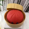 Detail showing a red baozi squishy toy with cute eyes in a yellow steamer container. - Steamed Bun Style (With Steamer) / Jumbo Flour Filled Version