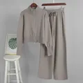 Detail of knitted two-piece set featuring double zipper top and wide-leg pants. - S / Top And Bottom / Light Coffee