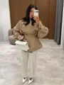 Full body mirror selfie of a woman wearing a chic khaki trench coat and white pants. - S / Tops / Khaki
