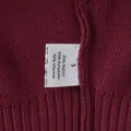 Close-up of maroon knitted sweater detailing the fabric texture and material care label. - S / Top And Bottom / Burgundy