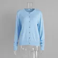 Detailed view of a light blue long-sleeved button-up knit cardigan for early autumn - S / Tops / Cardigans / Blue