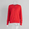 Detail view of a vibrant red knitted button-up cardigan with a classic round neckline - S / Tops / Red