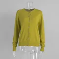 Macro detail of a mustard yellow knitted cardigan featuring front button closures. - S / Tops / Single Cardigan / Green