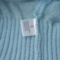 Close-up of washing label on blue mohair knit sweater showing material composition - S / Tops / Light Blue
