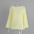Detail view of the sheer light yellow hollowed-out knit fabric and flared sleeve design - S / Tops / Yellow