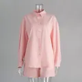 Macro detail of a pink cotton long-sleeve shirt and shorts casual set on mannequin - S / Top And Bottom / Light Pink