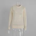 Detailed view of a cream mohair crewneck sweater showing delicate sheer knit texture - S / Tops / Apricot