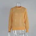 Detailed view of yellow semi-sheer mohair knit sweater featuring ribbed cuffs and hemline. - S / Tops / Yellow