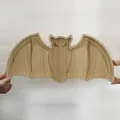 Detailed view of a bat-shaped wooden tray with natural grain for Halloween party decor - Bat