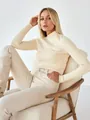 Close-up of a premium cream mock neck ribbed knit sweater for women in a studio. - One Size / Tops / Apricot