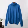 Nahaufnahme eines eleganten, blauen Oversize-Rollkragenpullovers aus weichem Strick. - Blau