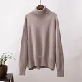 Detailansicht eines eleganten, lockeren Rollkragenpullovers in weichem Taupe-Strick - Hellbraun