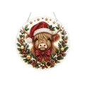 Ornamento natalizio mucca Highland con cappello di Babbo Natale e fiocco rosso. - Mucca Highland Scozzese
