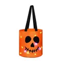 Close-up of an illuminated orange Halloween candy bucket with a glowing pumpkin face - Style A (Orange Pumpkin)