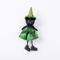 Detailed view of Halloween black cat witch doll in green hat and skull dress - Black Cat Pendant