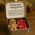 Close-up of a festive Christmas gingerbread pocket hug gift set in a silver tin box. - Gingerbread Man