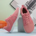 Close-up of pink lightweight barefoot training shoes with breathable mesh upper and wide toe - Pink