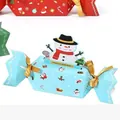 Detail view of a Christmas candy gift box featuring a snowman pull tab and gold ribbon - Candy Christmas Money Bag-Blue