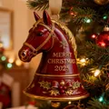Detailed macro view of a red ceramic horse head bell ornament hanging on Christmas tree - Horse Bell Style