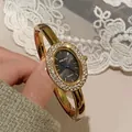 Elegante goldene Vintage-Armreif-Uhr mit ovalem Gehäuse und Strassbesatz für Damen - Goldarmband Schwarzes Zifferblatt Strass-Stil / Gold (Schwarzes Zifferblatt)