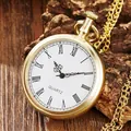 Detailed close-up of vintage gold pocket watch with Roman numerals on a wood surface - Gold