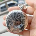 Detailed macro shot of a vintage silver skeleton pocket watch with mechanical gears. - Silver