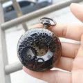 Detailed macro view of the intricate mechanical gear hollow design of the retro pocket watch. - Black